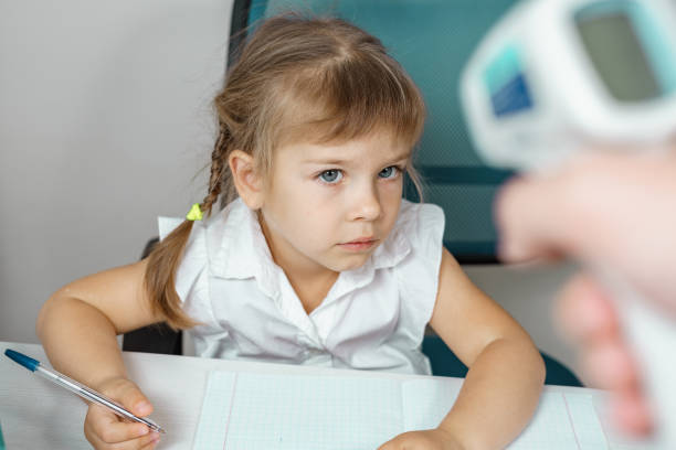 istock temperature is measured for a child at school 1280179221