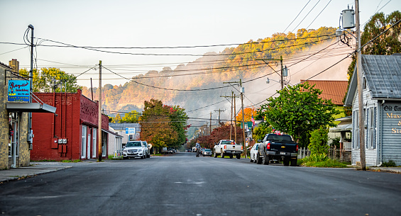 Marlington, USA - October 7, 2020: Town in West Virginia countryside and house buildings downtown main street road with shops store and morning fog mist
