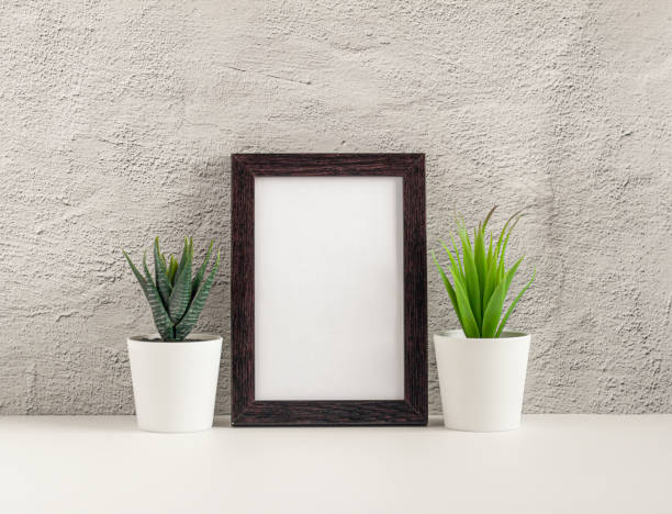 istock Empty photo frame on a table or shelf with a copy of the place 1280180163
