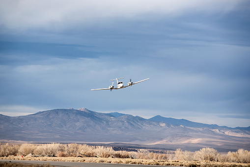 Twin engine Piper PA-44-180T making Photo Op runway approaches and departures at sunset at Bishop Airport, Bishop Airport