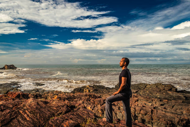 istock man at rocky sea shore in the morning from flat angle 1280182117