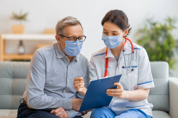 istock Doctor and senior woman wearing facemasks 1280184647