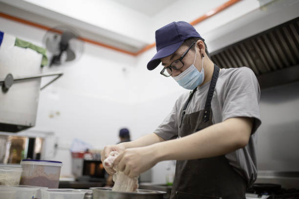 istock Asian Chinese owner chef preparing food in kitchen. 1280185255