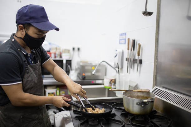 istock Asian owner chef is cooking in commercial kitchen. 1280185287