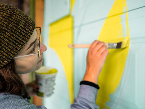 istock Female mural artist at work 1280185627