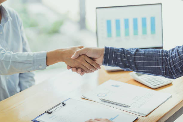 istock Business executives handshake in meeting room. 1280185630