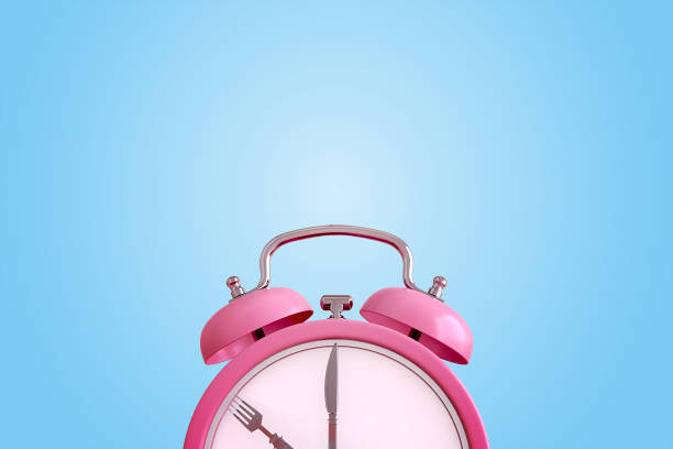 istock Alarm clock with cutesy, Concept for intermittent fasting diet, meal time or appointment schedule. 3d rendering 1280185649