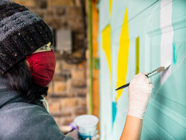 Female mural artist at work
