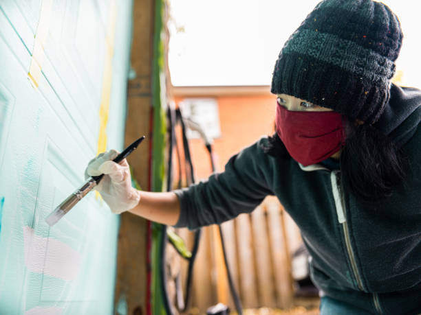 istock Female mural artist at work 1280185817