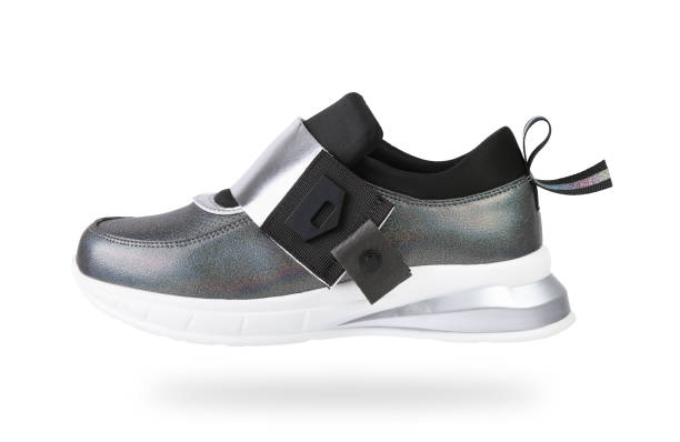istock Women's stylish silver sneakers with a white sole on a white background. 1280185932
