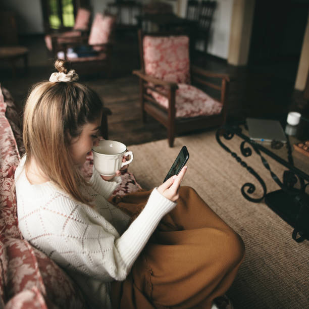 istock Young woman using phone at home 1280186047