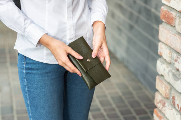 istock A girl holding a purse in her hand 1280188167