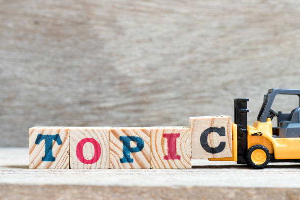 istock Toy forklift hold letter block c to complete word topic on wood background 1280189176