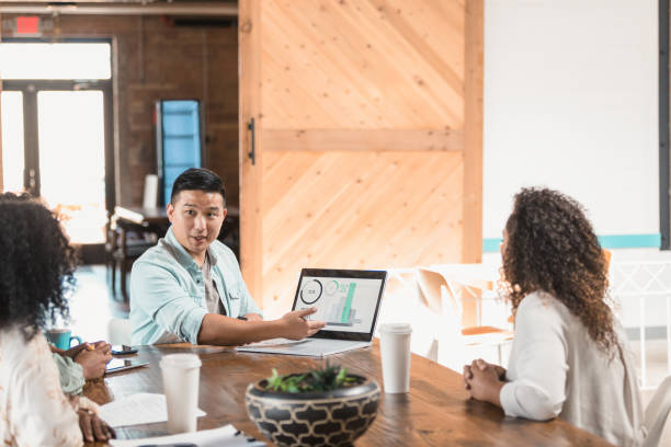 istock Man uses graphs as part of presentation to colleagues 1280190176