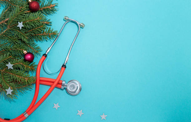 istock Phonendoscope with Christmas decorations on a blue background. Copy space. 1280190187