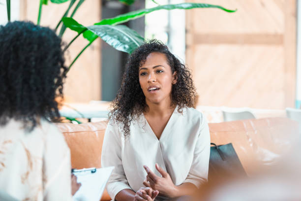 istock Vulnerable woman talking with female counselor 1280190258