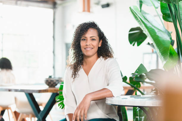 istock Cheerful woman in coffee shop 1280190304