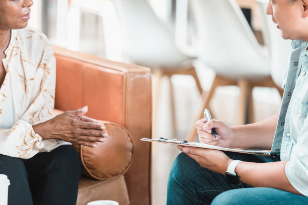 istock Vulnerable, unrecognizable woman speaks during therapy session 1280190350
