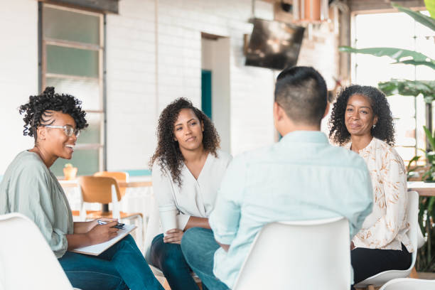 istock Group listens as unrecognizable mid adult man speaks 1280190380