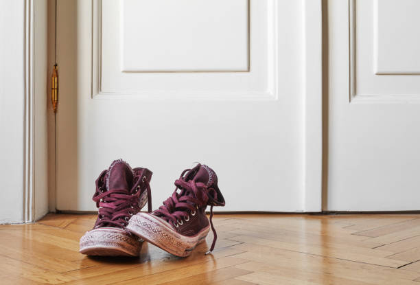 istock Old canvas shoes on floor 1280190725