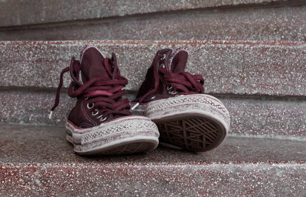 istock Dirty canvas shoes on stairs 1280190741