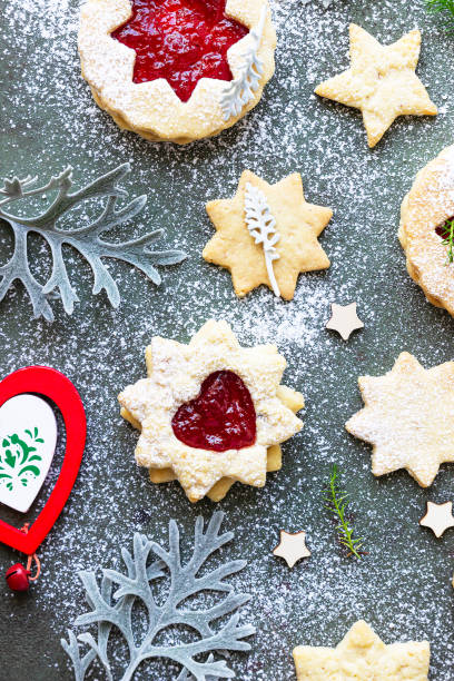 istock Traditional Linzer Christmas cookies with raspberry jam on green stone background. Flat lay. Festive decoration. 1280191767
