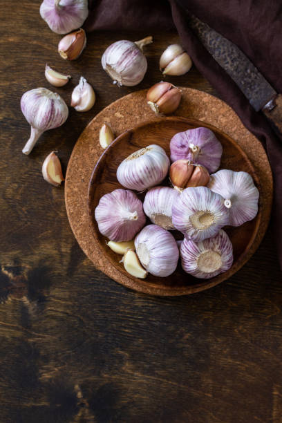 istock Garlic. Garlic Cloves and Bulb on rustic wooden table. Top view flat lay background. Copy space. 1280191930