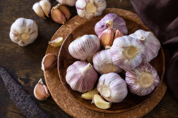 istock Garlic. Garlic Cloves and Bulb on rustic wooden table. 1280191932