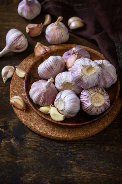 istock Garlic. Garlic Cloves and Bulb on rustic wooden table. Copy space. 1280191933