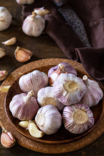 istock Garlic. Garlic Cloves and Bulb on rustic wooden table. 1280191939