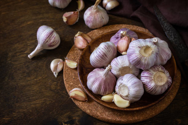 istock Garlic. Garlic Cloves and Bulb on rustic wooden table. Copy space. 1280191941
