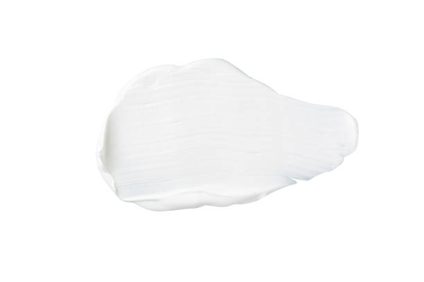 istock Color corrector strokes isolated on white background. White cream smudge smear swatch sample. Makeup foundation creamy texture. 1280192753