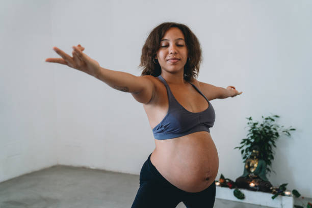 istock Young woman practicing yoga during her pregnancy 1280193691