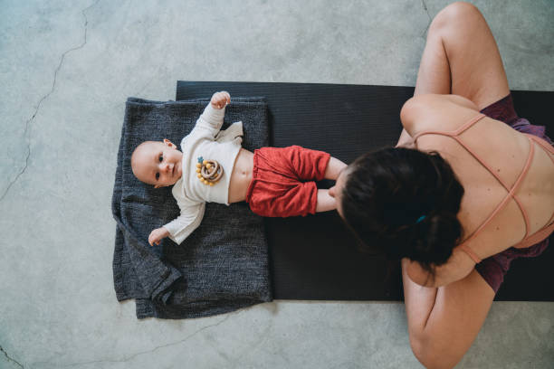 istock Mother having fun with her little kid during a yoga class 1280193783