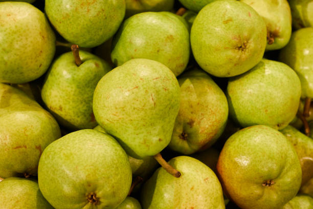 istock Green large pears on the supermarket shelf 1280195555