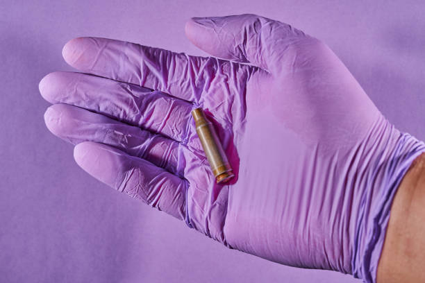 la mano de un hombre con un guante sosteniendo un proyectil de bala - armed forces human hand rifle bullet fotografías e imágenes de stock