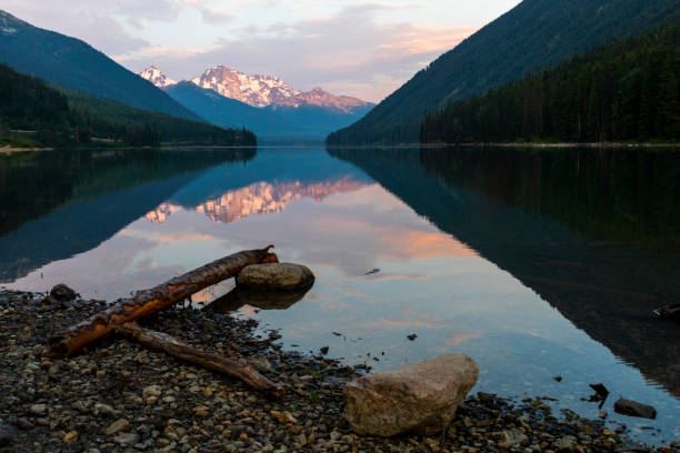 istock Mountain range reflecting in smooth surface of Duffey Lake at sunrise 1280196780