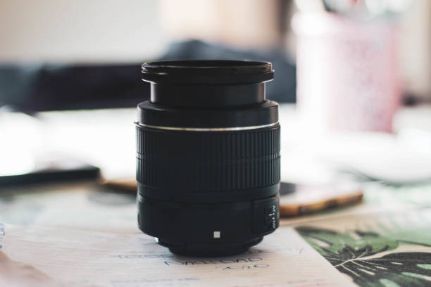 istock camera lens on top of notes and papers on a table 1280198210