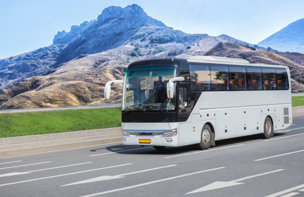 istock bus moves along the road along the mountain 1280198388
