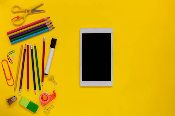 istock School and office supplies with digital tablet on yellow background 1280199664