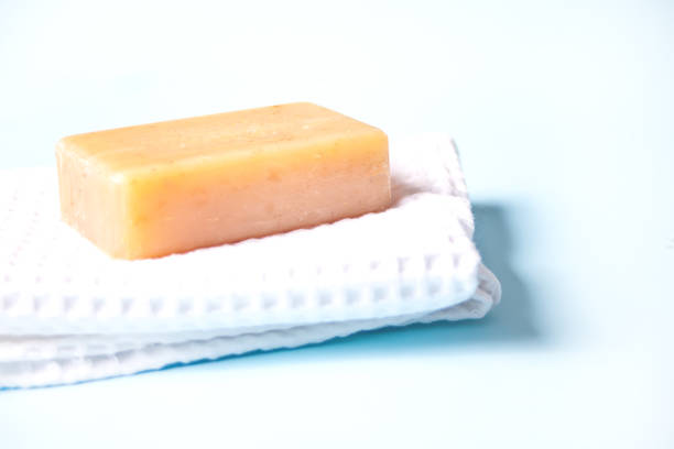 istock soap bar on white bath towel, light blue background 1280200642