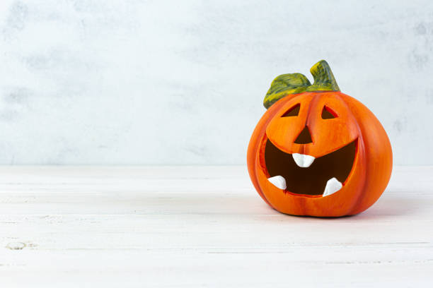 istock Orange decorative cheerful pumpkin lantern on a light background. Halloween, All Saints Day, a traditional fall holiday. 1280201877