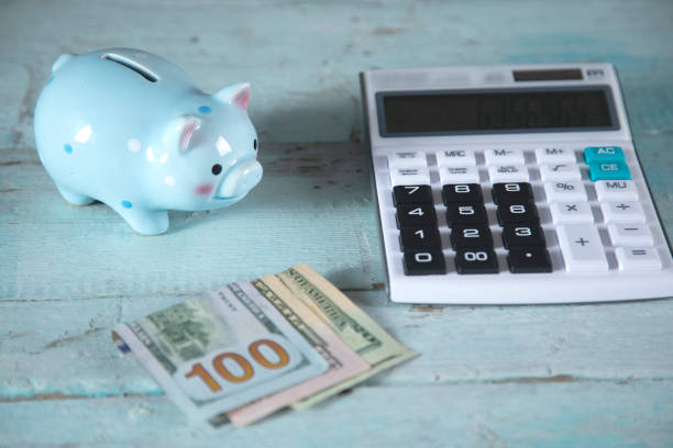 istock piggy bank and money with calculator 1280203849