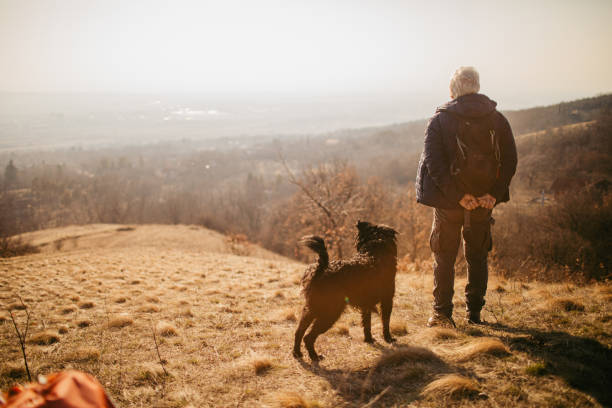 istock Senior man hiking with his best friend 1280204540