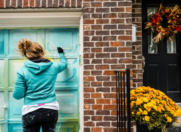 istock Female mural artist at work 1280206002