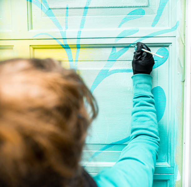 istock Female mural artist at work 1280206038