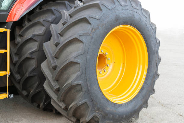 istock Two large wheels from a tractor or agricultural machinery close-up. 1280206181