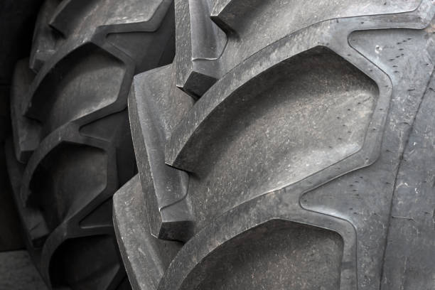 istock Two large wheels from a tractor or agricultural machinery close-up. 1280206189