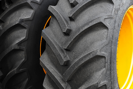 Two large wheels from a tractor or agricultural machinery close-up.