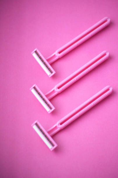 istock Three isolated pink plastic female razors for single use on a same pink background. 1280207159
